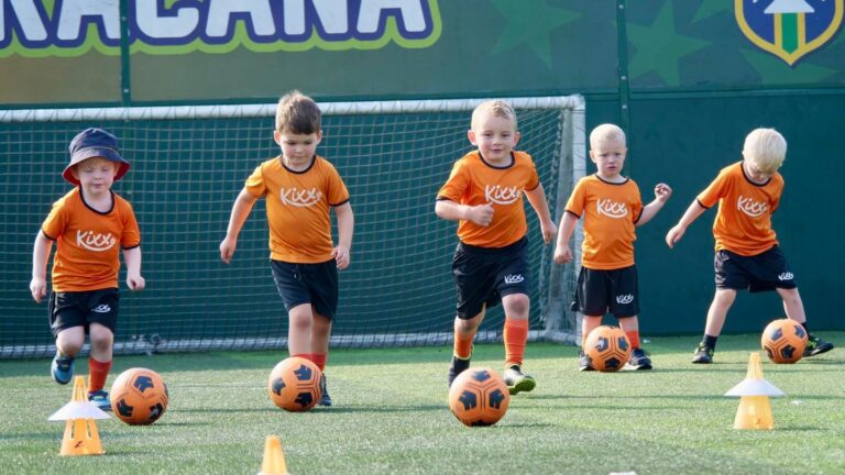Image of five little boys playing football at Kixx session to illustrate blog about football lessons for 3 year olds