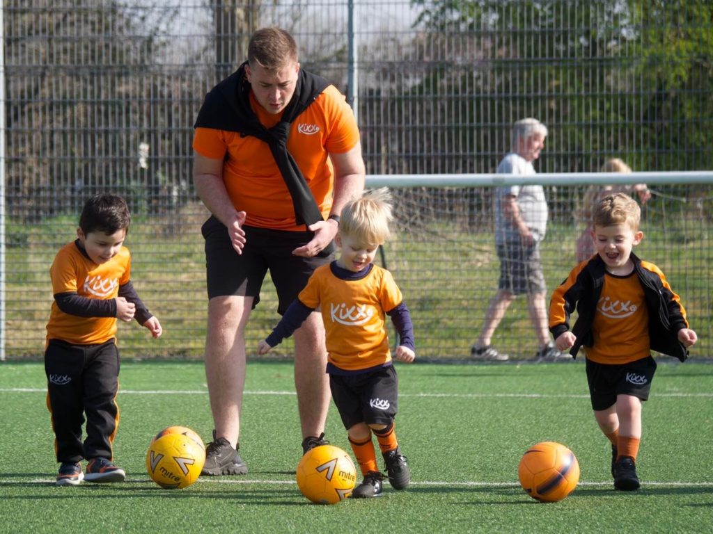 Children playing football with Kixx coach