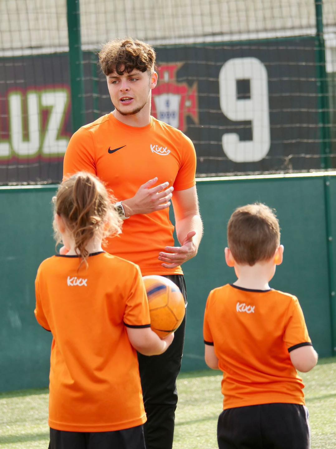 Image of coach teaching children's football lessons at Kixx
