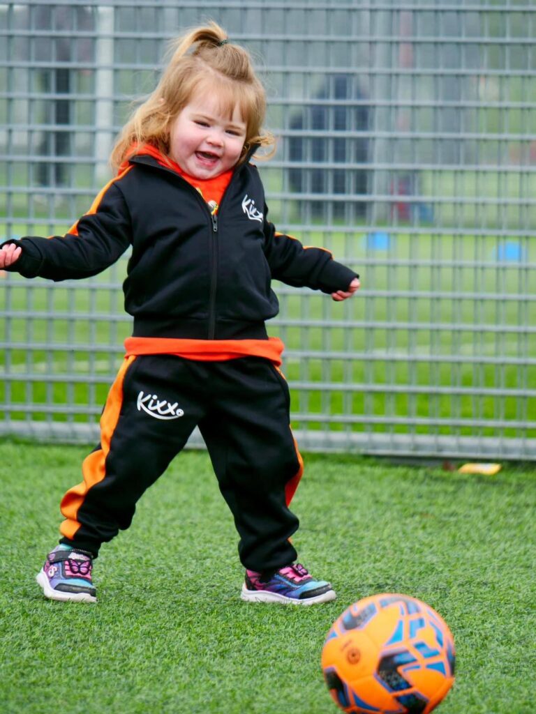 image of girl playing football for blog 3 Fun Ways to Introduce Football For Under 5s At Home