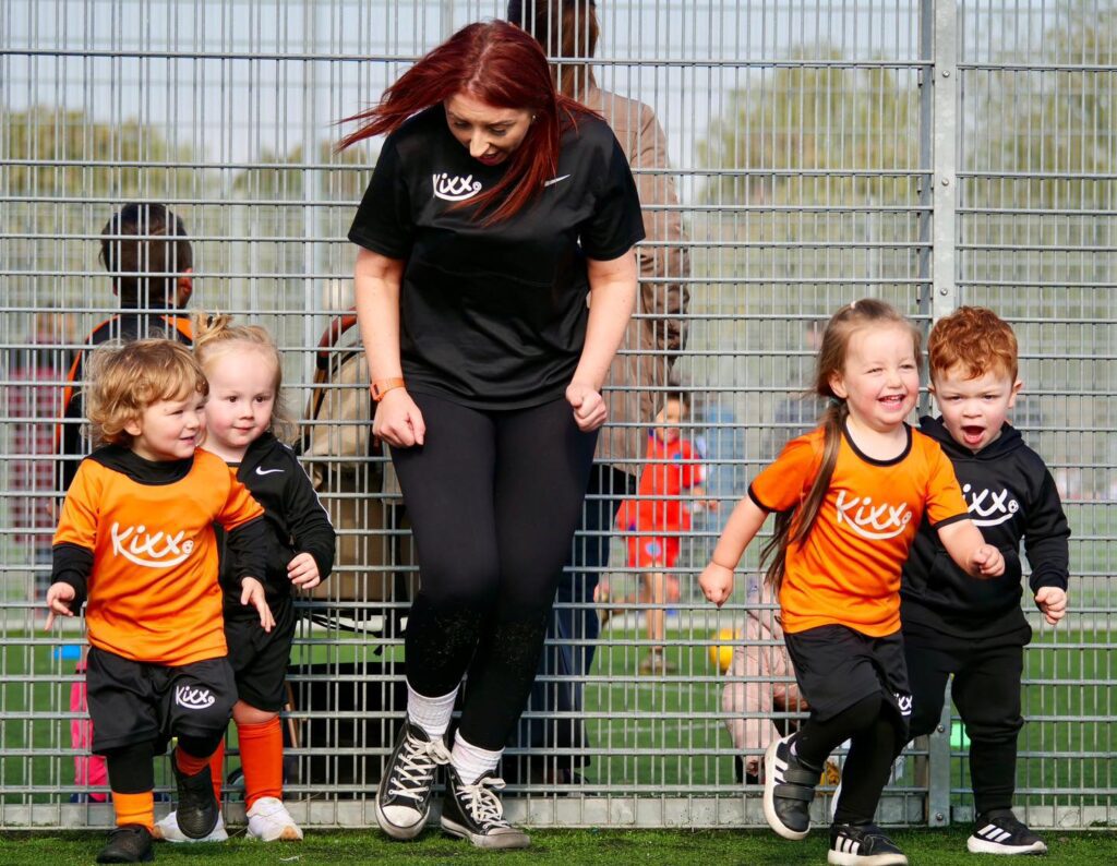 Image of team orange at practice for blog title 3 Ways To Perfect Your Passing In Football Lessons