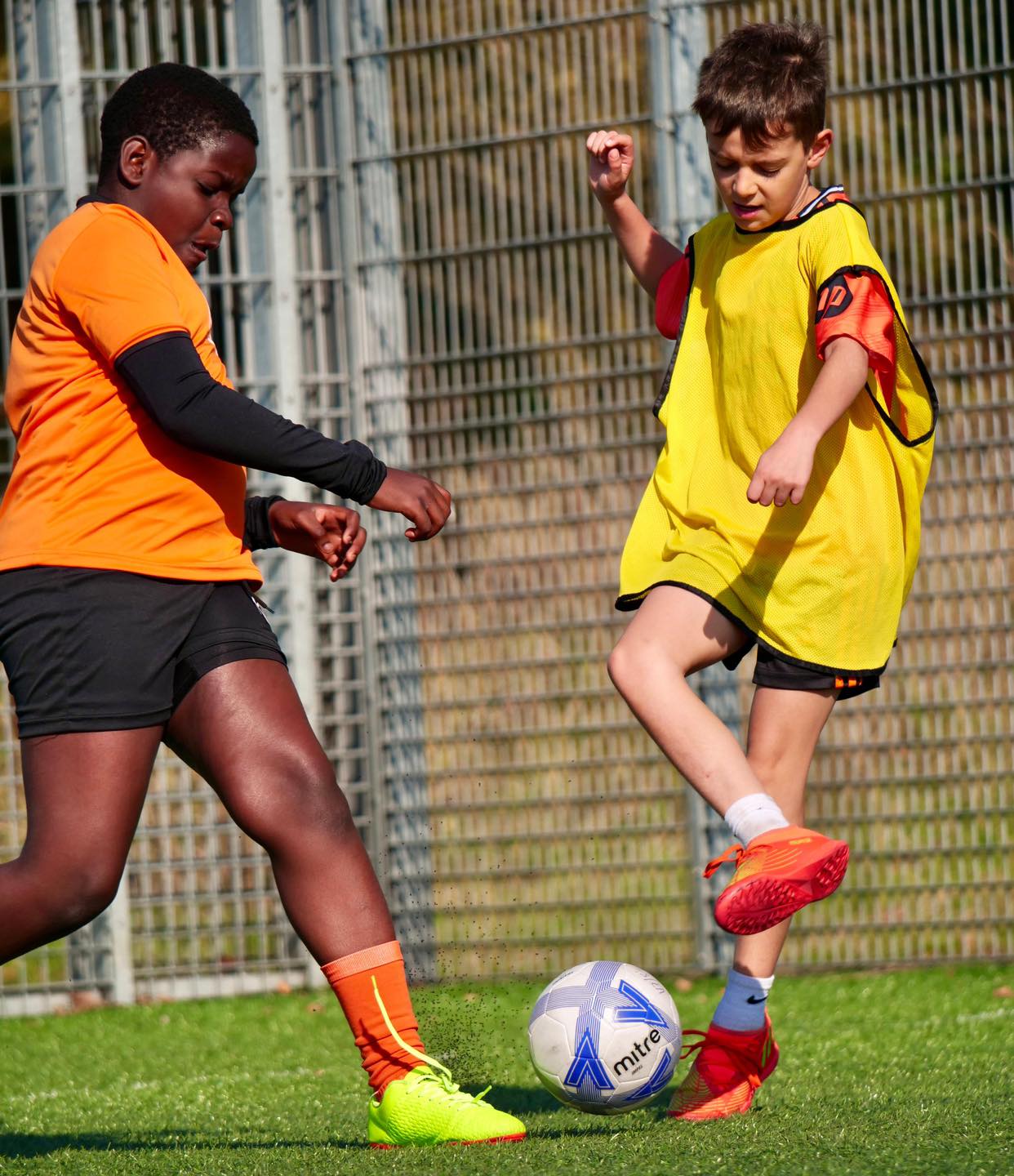 Image of two young boys playing football for the blog Is 10 Years Old Too Old To Start Football Classes?