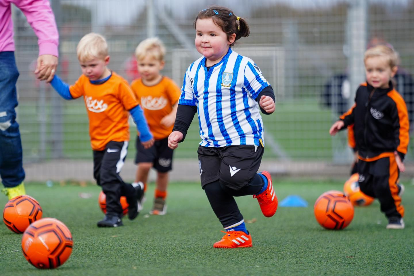 Image of a group of children having fun at Kixx practice for the blog What Life Lessons Are Children Taught At Our Football Coaching Academy