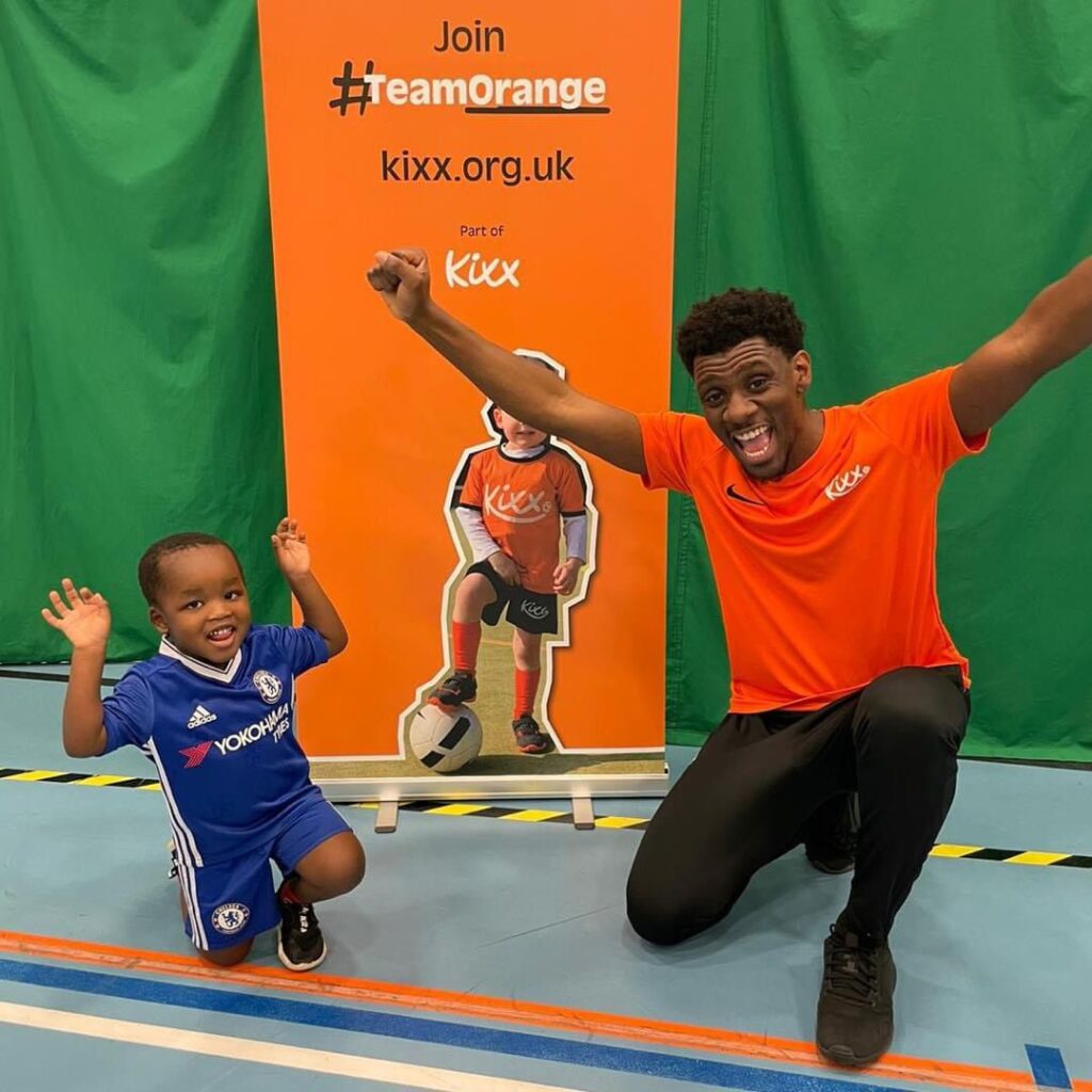 Image of a Kixx coach with a child customer with their arms raised as if to say 'Hurrah!' for a blog by Kid's football coaching company Kixx. The blog is titles '5 reasons to become a Kixx Franchisee in 2025