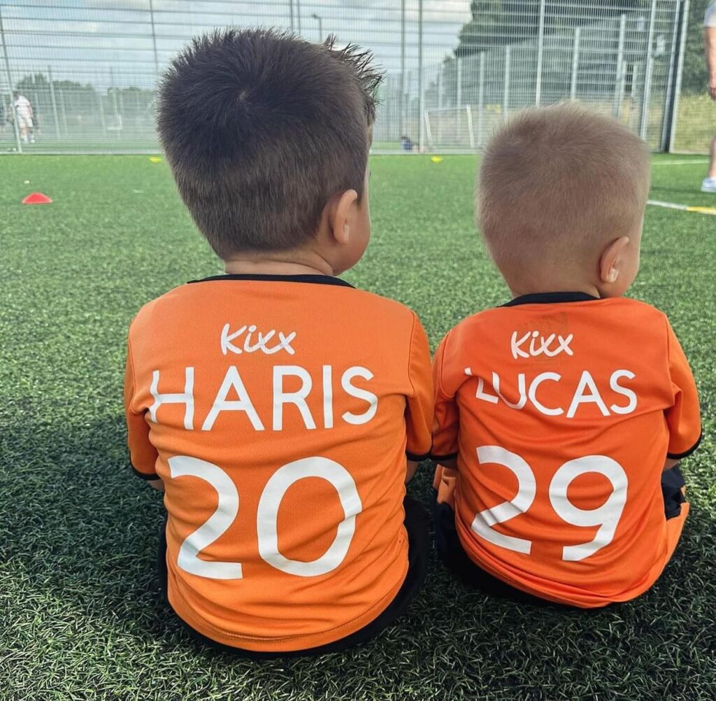 Image of two young Kixx players sitting together at practice for blog The 3 Signs Your Infant Is Ready To Join Football Classes